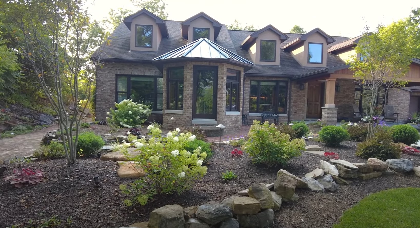 Beautiful residential landscape design with stone features and professional plantings