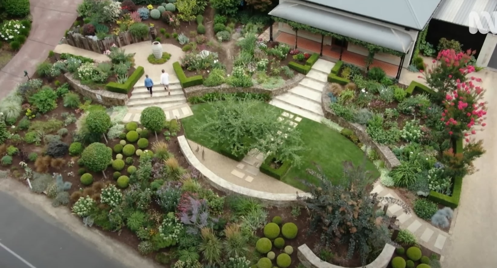 Overhead view of professional landscape design with geometric patterns and structured planting beds Aerial view of geometric garden design with curved pathways and structured landscape beds