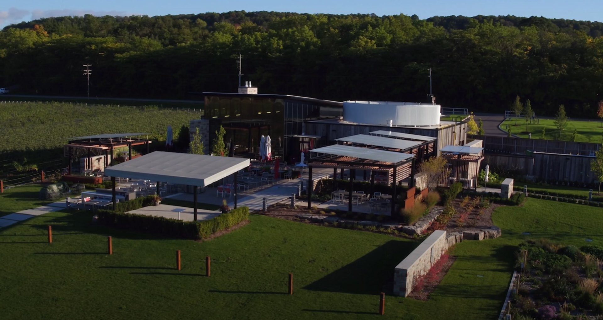 Large-scale commercial landscaping project with modern architecture and professional grounds management Commercial landscape architecture with modern building and extensive grounds maintenance